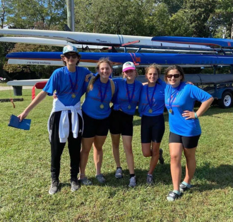 Matt Hall, Katia Bass, Hannah Taczak, Izzie Van Deman, Molly Western. Pictured after womens novice 4 boat won their race posing with medals