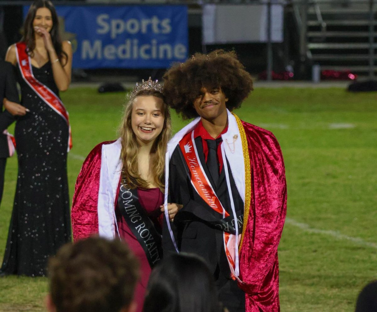 Seniors Charlotte Underwood and Jayden Blackman on the football field during the halftime ceremony. 