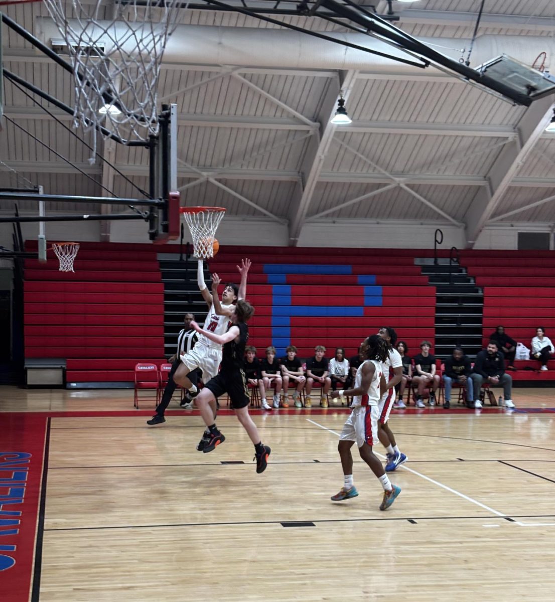 Sophomore Gabe Williams goes for a layup against Cox High School.