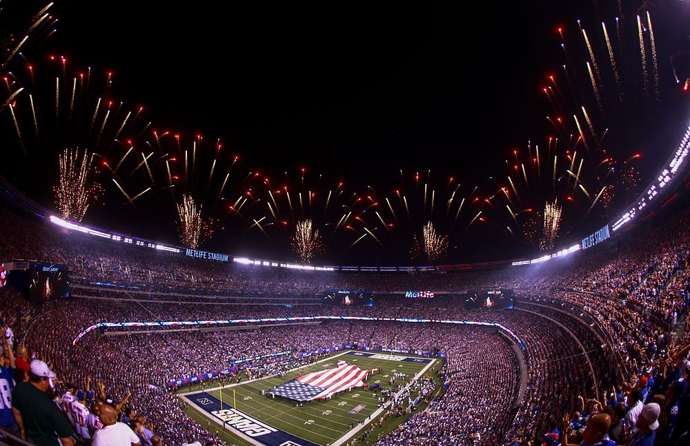 U.S. Marines, Sailors, Coast Guardsmen, Airmen and Soldiers unfurl an American flag across the field at MetLife Stadium, East Rutherford, N.J., Sept. 5, 2012, during a pre-game ceremony before the New York Giants versus Dallas Cowboys football game.