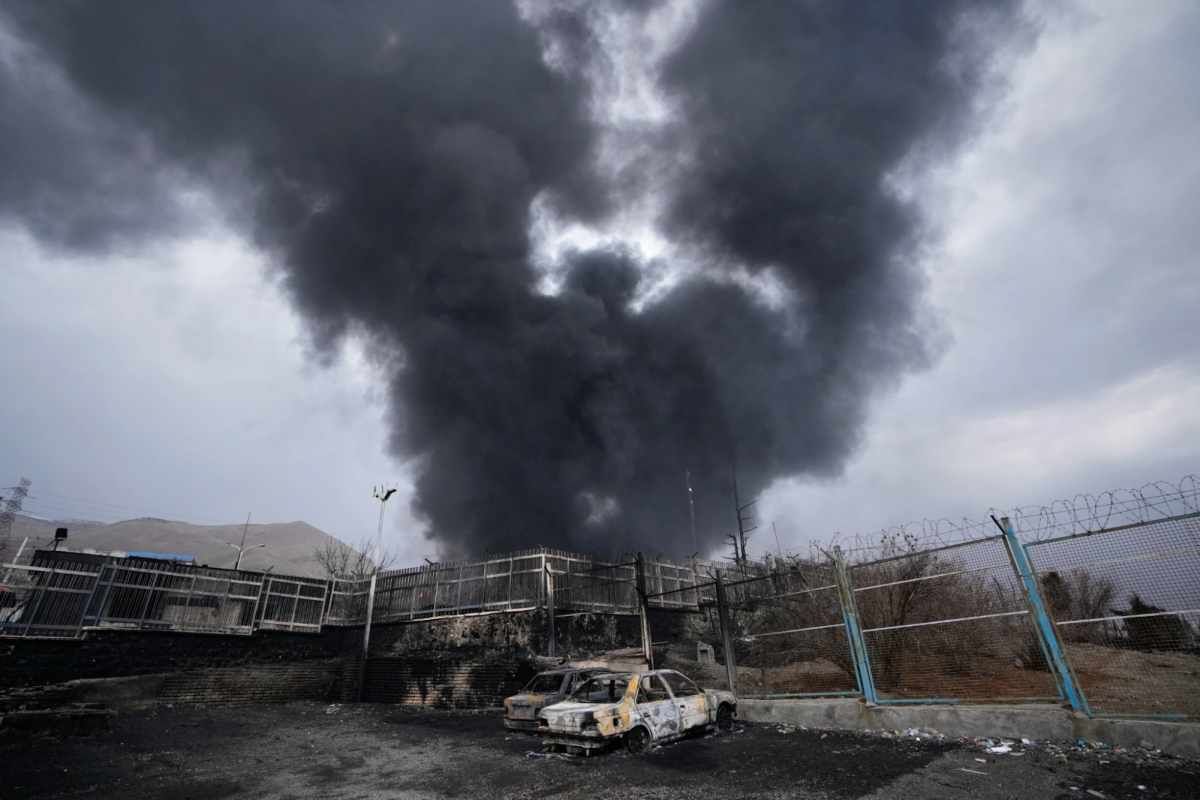 Plumes of smoke rise above an oil facility hit in the U.S.-Israeli airstrikes on February 28, 2026. Provided by AP News.